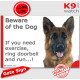 Medium longhaired German Shepherd, funny Portal Sign "Beware of the Dog, need exercise, ring & run" gate photo hilarious notice